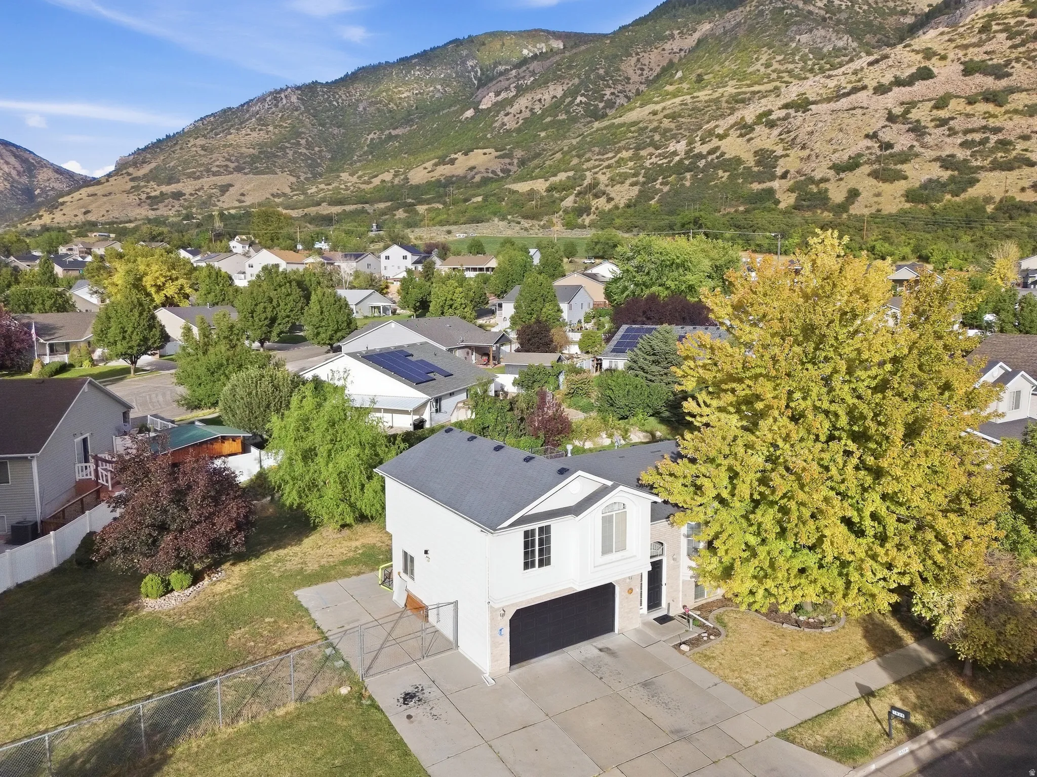 Two-story residence with a two-car garage, concrete driveway, and established landscaping