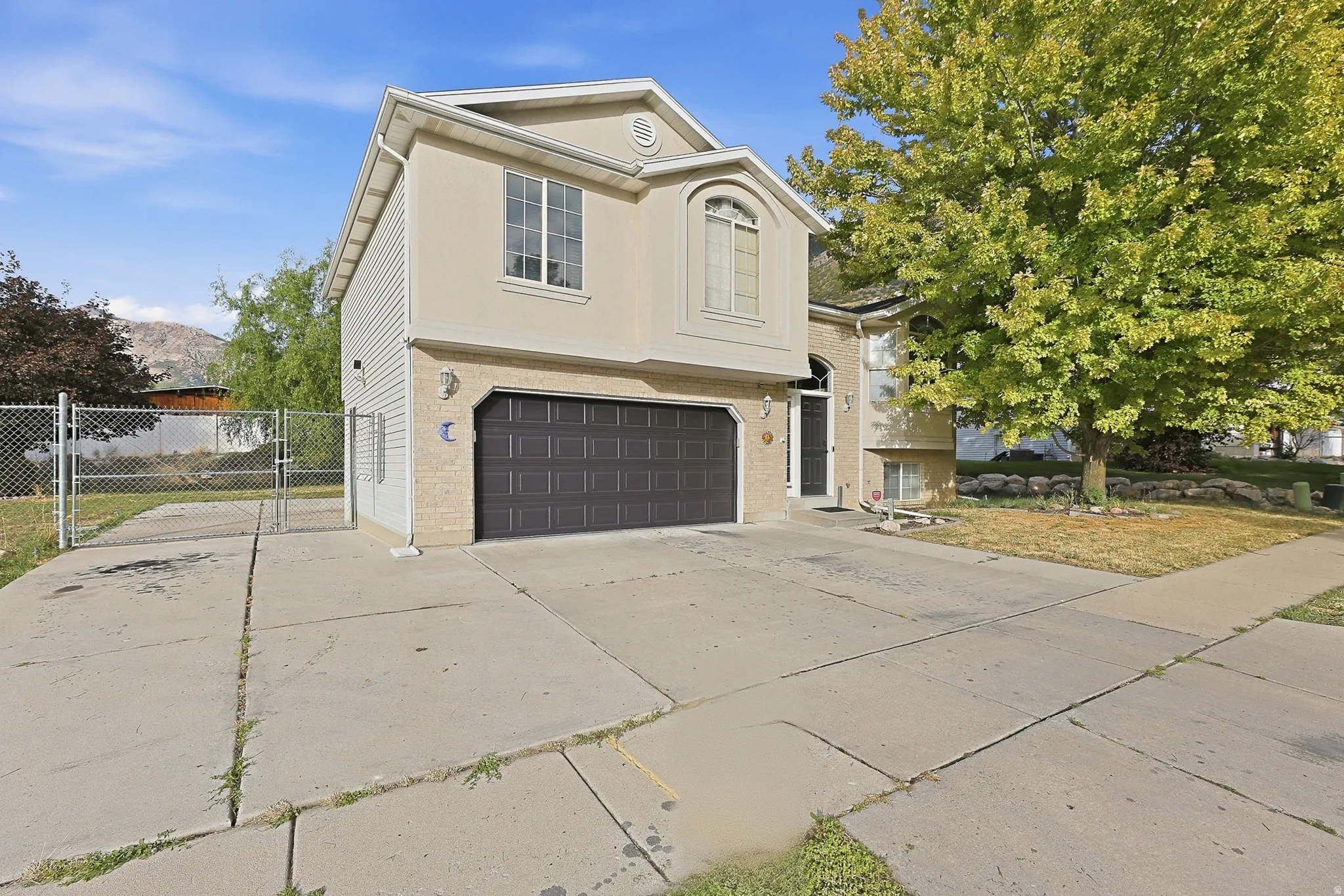 Two-story exterior with a two-car garage, stucco siding, and a concrete driveway