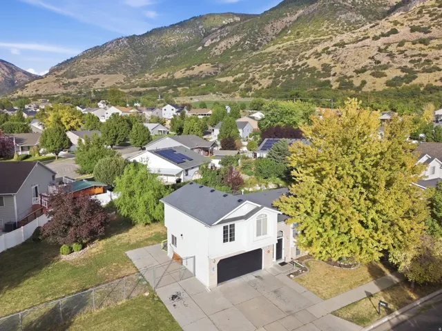 Two-story residence with a two-car garage, concrete driveway, and established landscaping