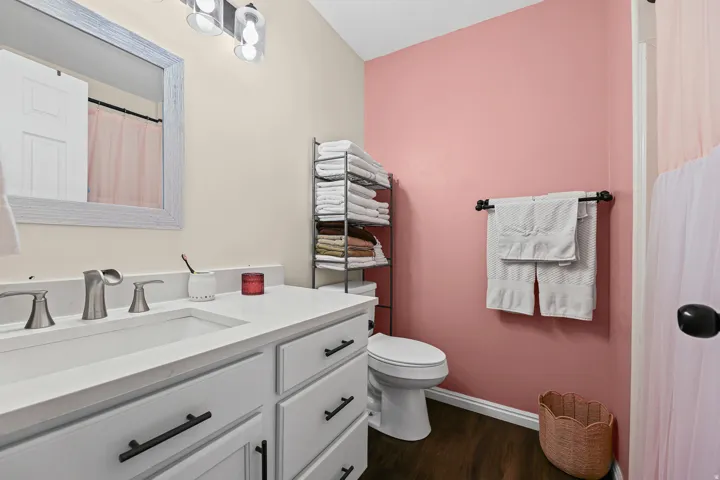 White vanity with matte black hardware, integrated sink, and brushed nickel faucet