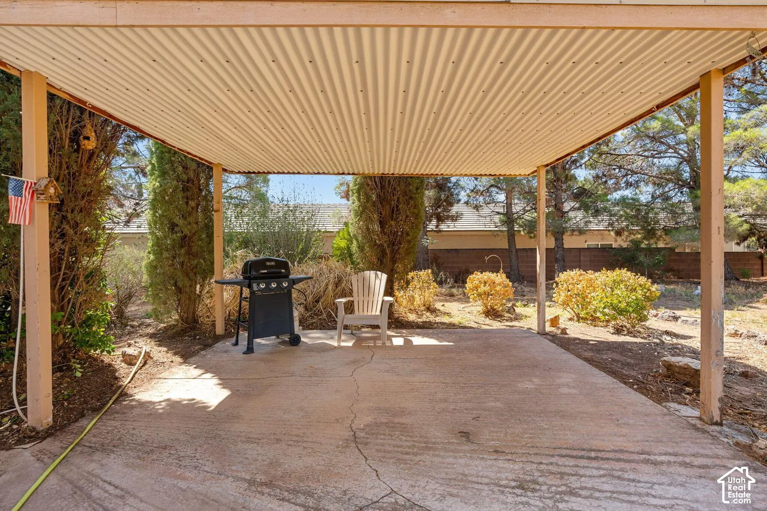 Covered concrete patio with corrugated roof