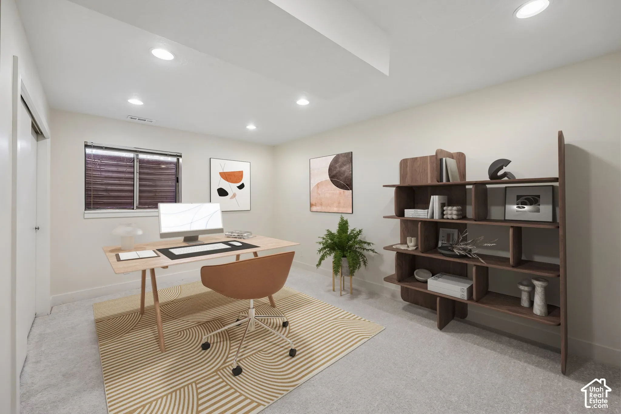 Recessed lighting illuminating neutral wall tones and light-toned carpeting