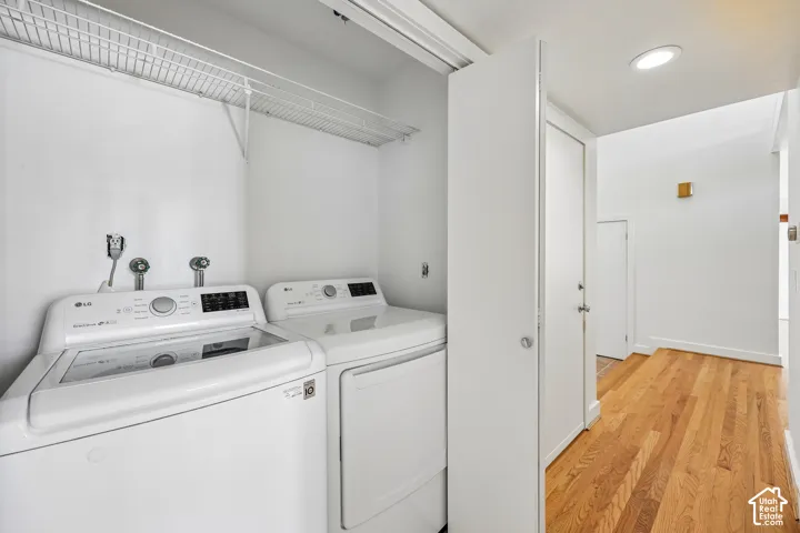 Dedicated laundry space featuring a white wire shelf, washer, and dryer