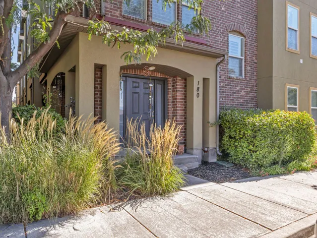 Brick facade with stucco accents and arched entryway