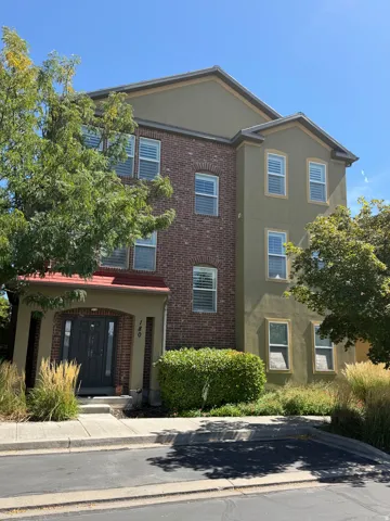 Multi-story exterior featuring brick and stucco siding
