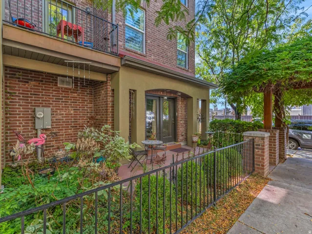 Brick exterior with a second-story balcony featuring black iron railings