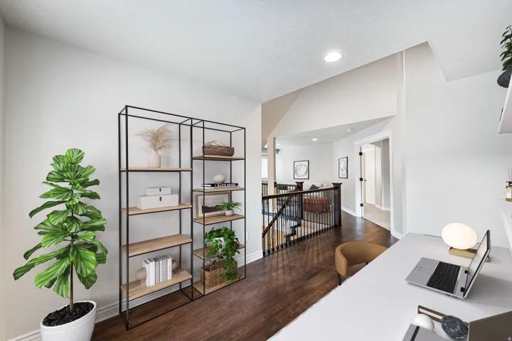 Built-in shelving unit with wood-finish shelves and dark metal framing, recessed lighting, and wood-finish flooring