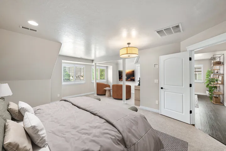 Recessed lighting, arched interior doorway, carpeted flooring, window shutters, and a drum pendant light fixture