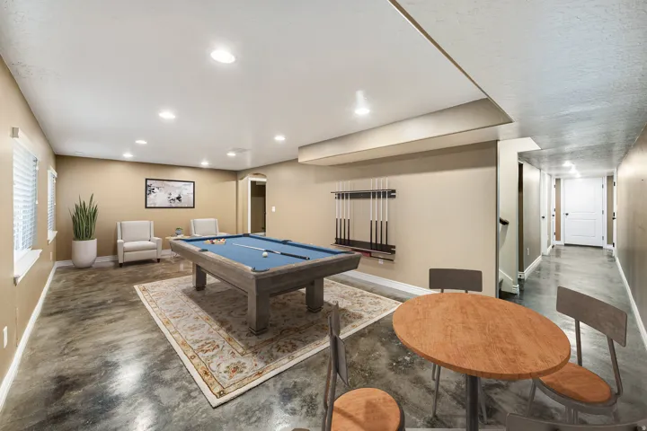 Recessed lighting illuminates the open area featuring hard-surface flooring and multiple windows