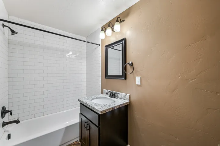 White subway tile shower surround with black fixtures
