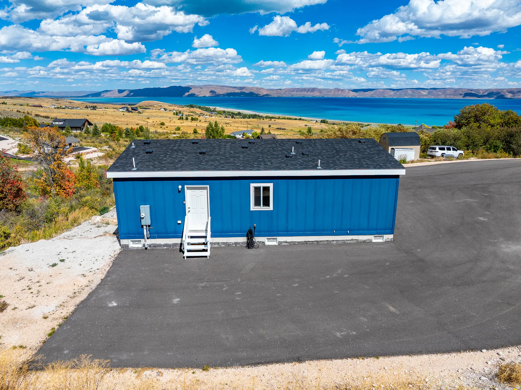 Blue exterior siding with a dark asphalt shingle roof