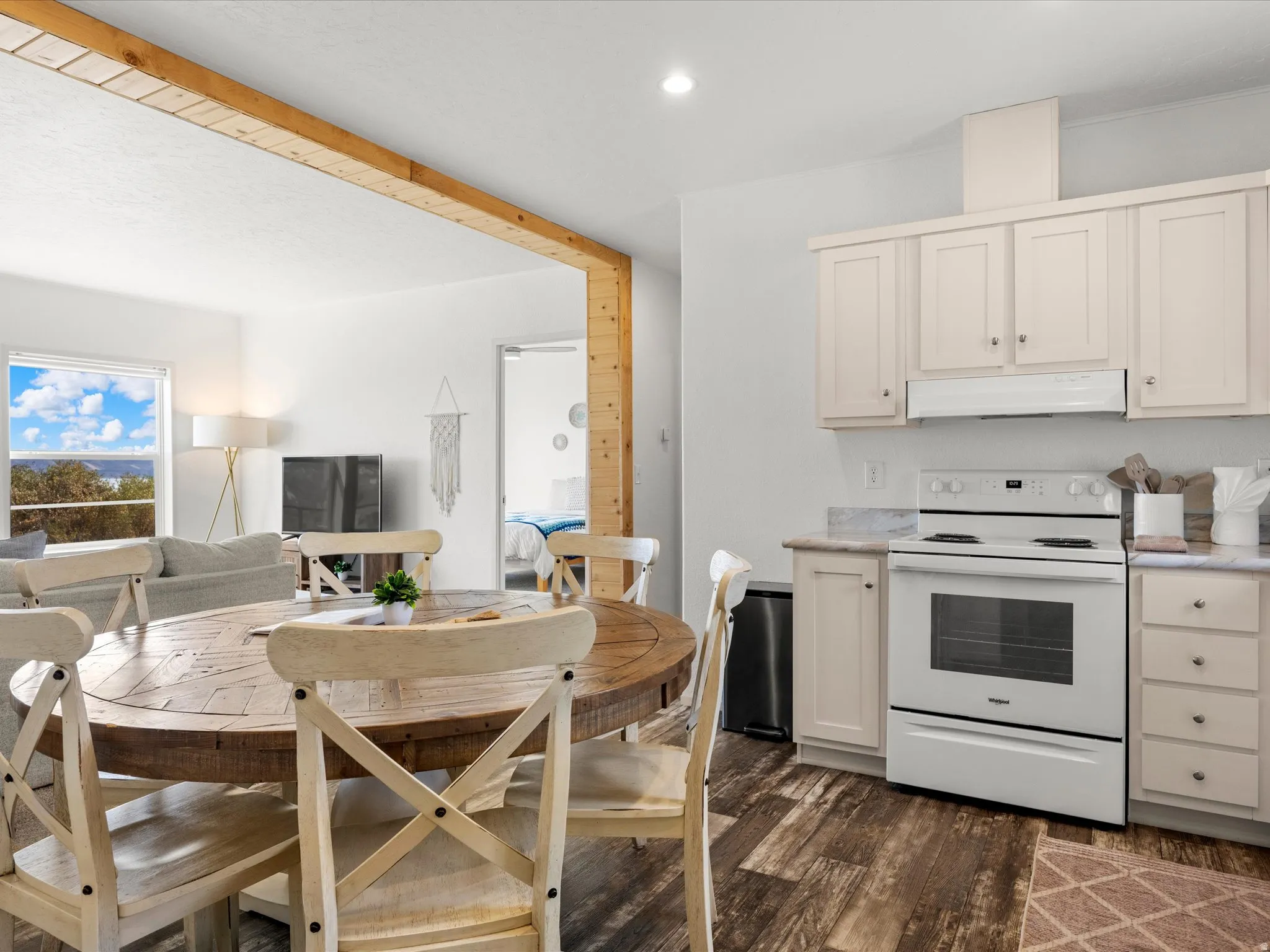 Kitchen featuring white cabinetry, white range, and stone-finish countertops