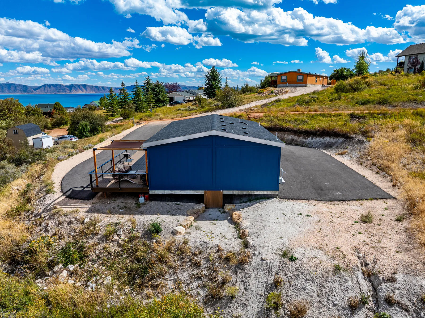 Blue exterior siding with a dark asphalt shingle roof, Lake view