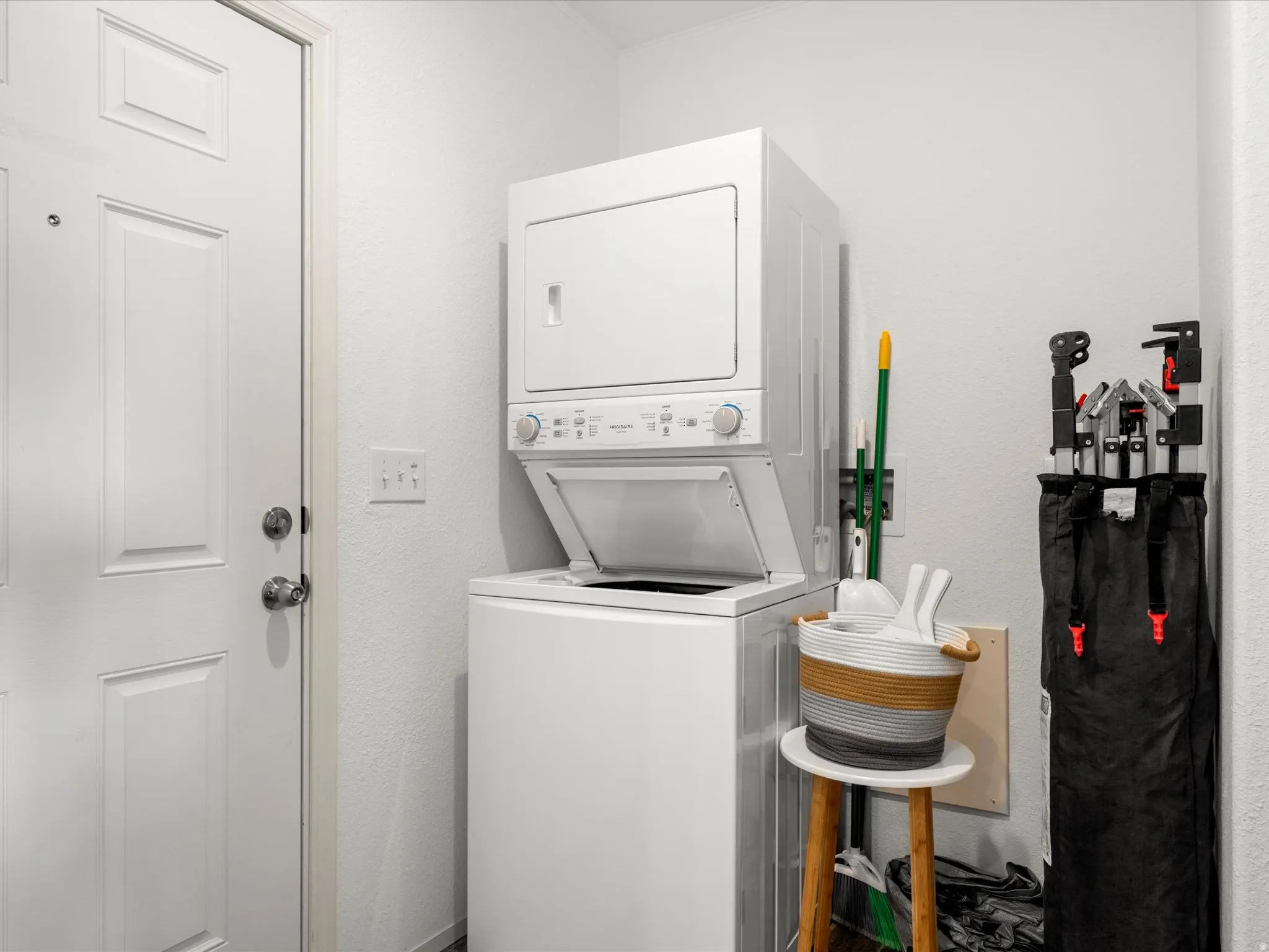 laundry with stacked washer and dryer