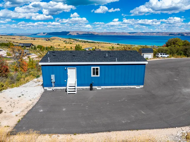 Blue exterior siding with a dark asphalt shingle roof