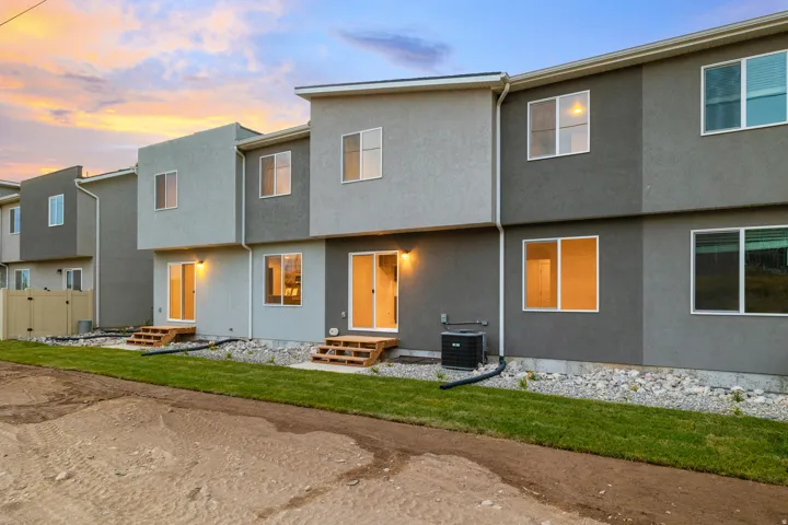 Rear townhouse elevations featuring two-tone stucco finishes and multiple sliding glass doors