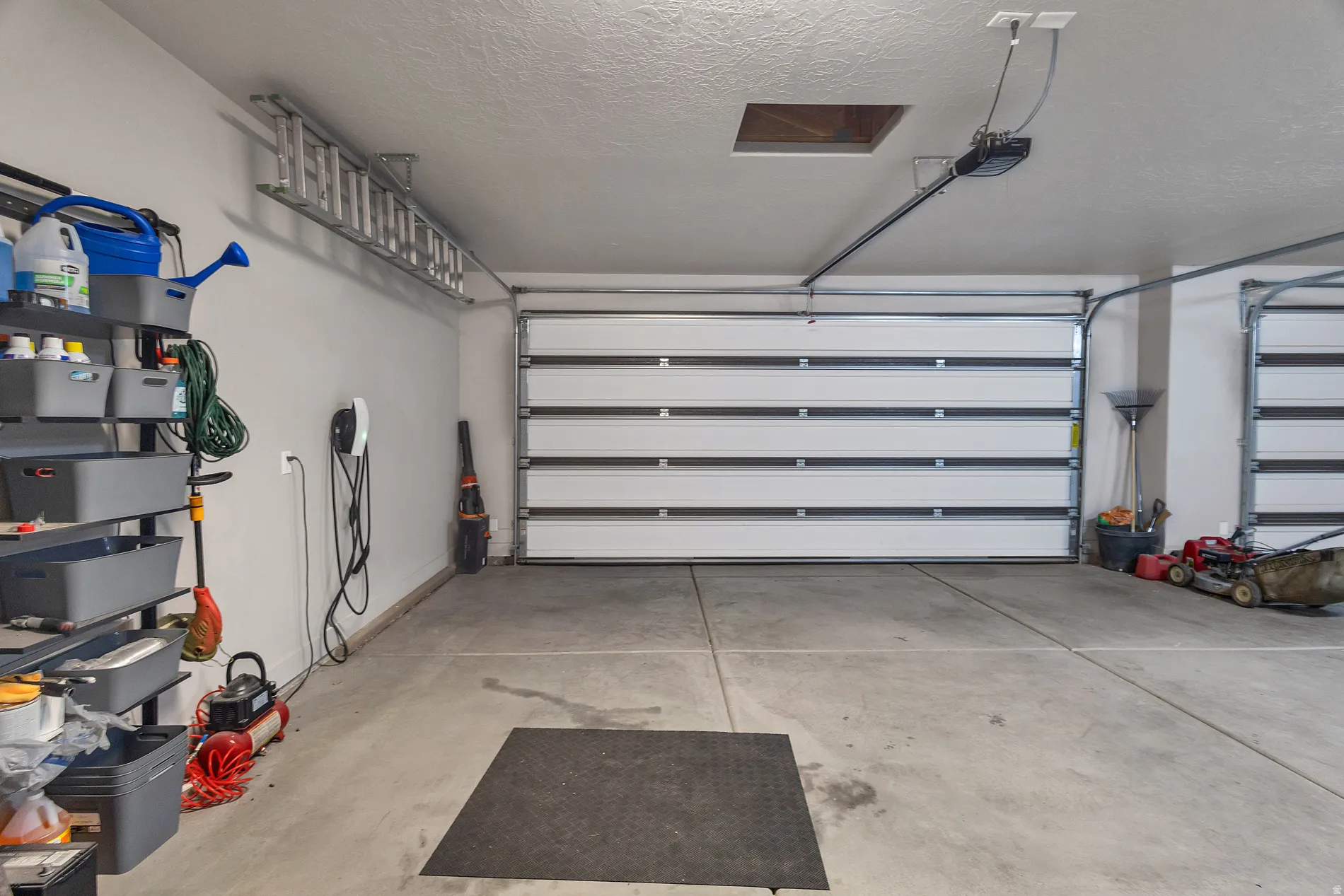 Two white sectional garage doors with automatic openers