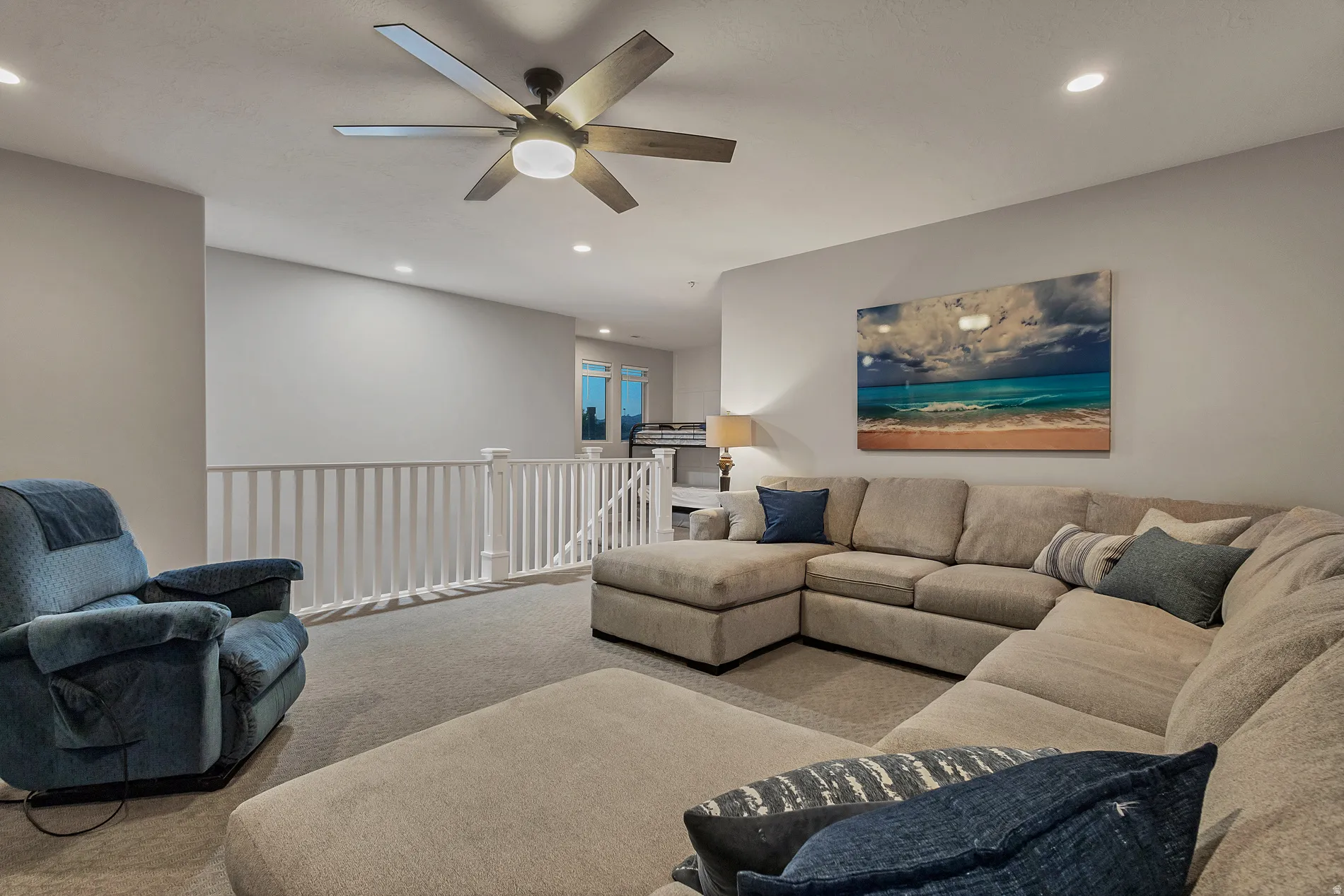 Recessed lighting illuminates the carpeted floor