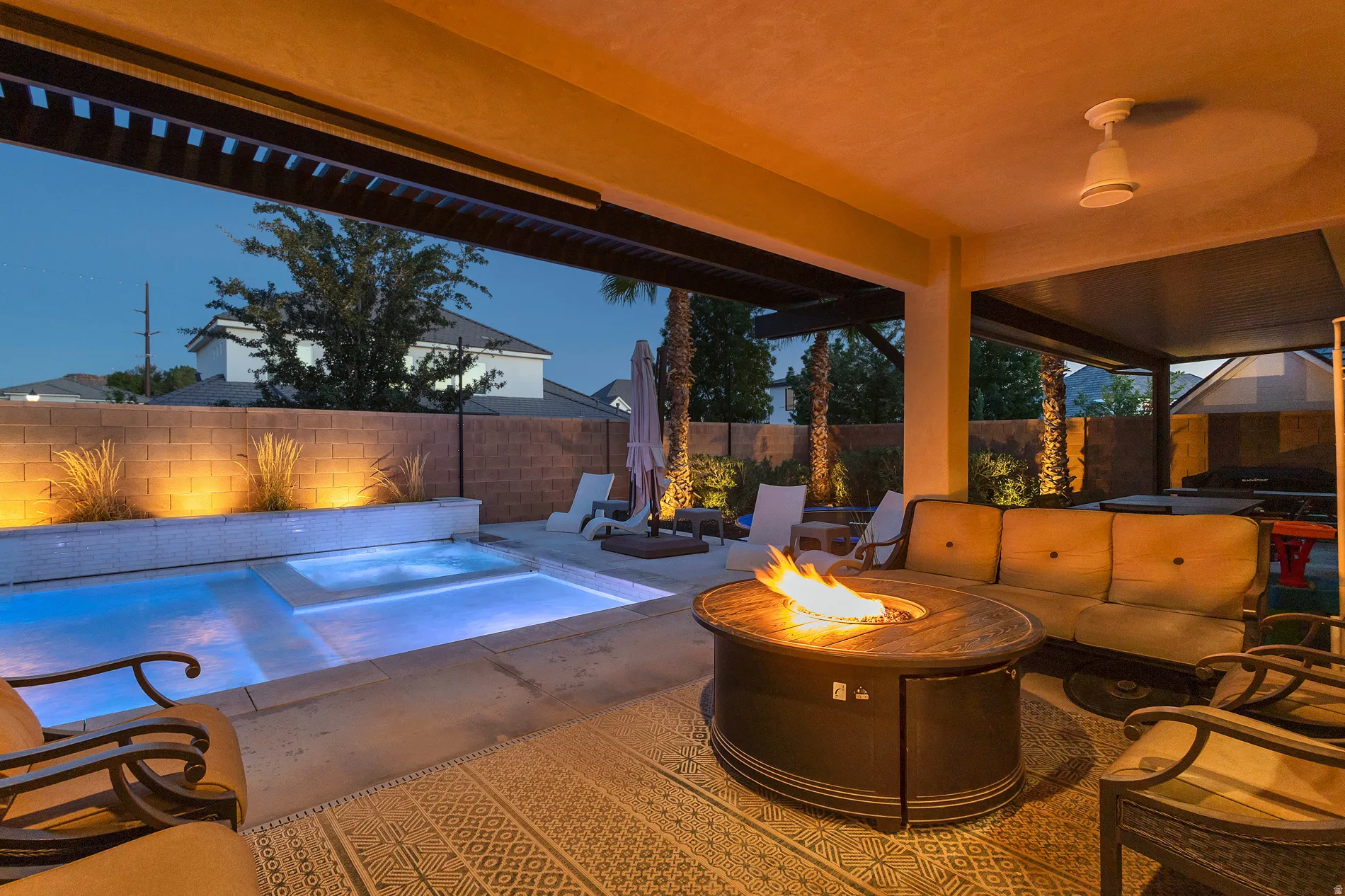 Covered patio with a ceiling fan, a swimming pool, and an integrated spa