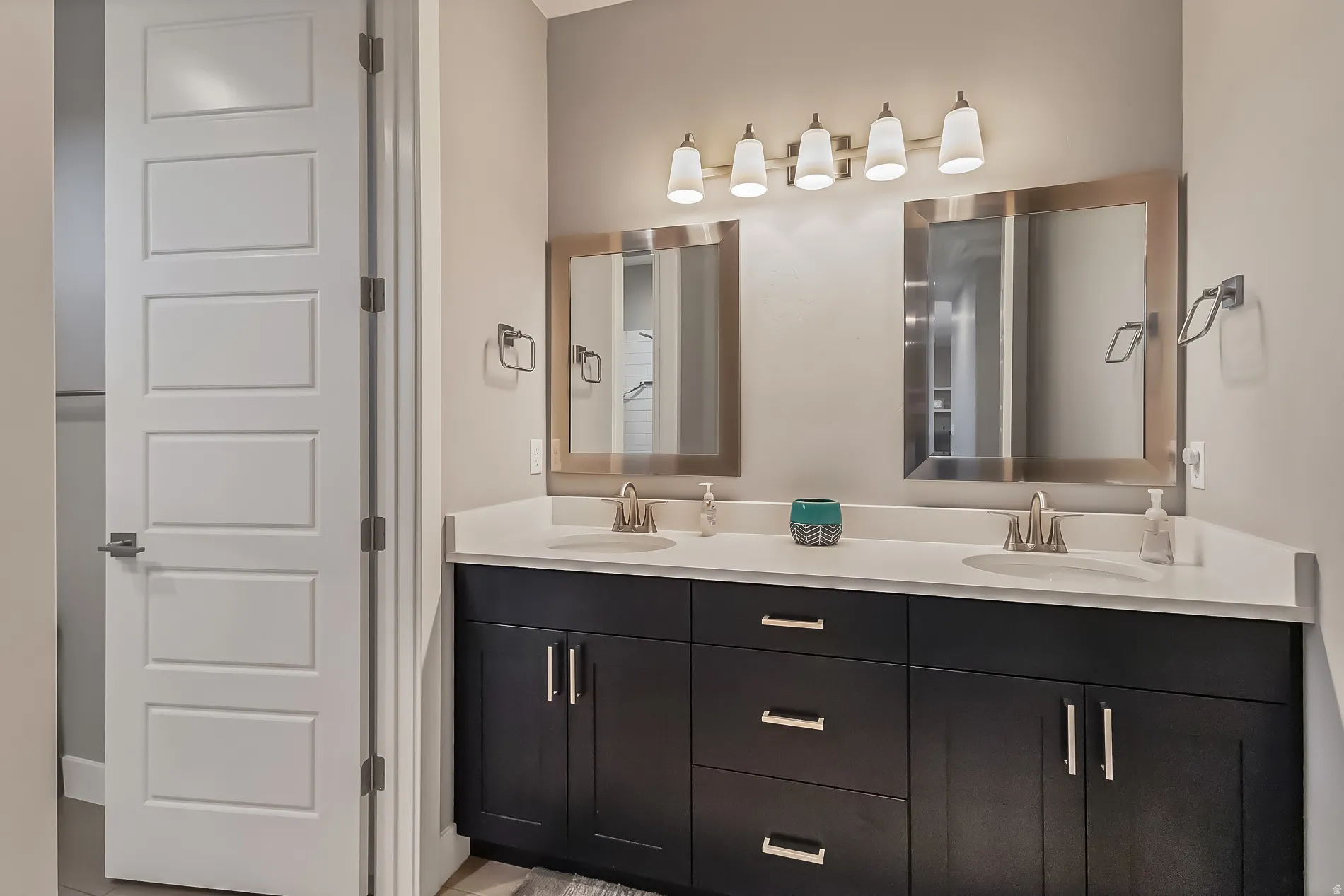 Double vanity with white countertops, undermount sinks, and brushed nickel fixtures