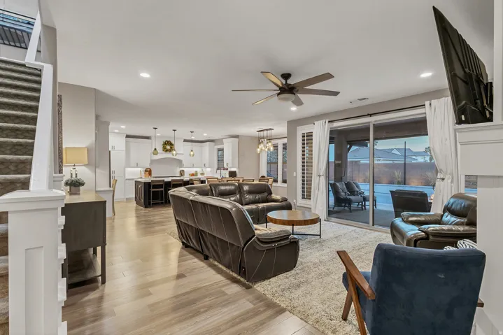 Open-concept living space featuring wood-finish flooring, recessed lighting, and a ceiling fan