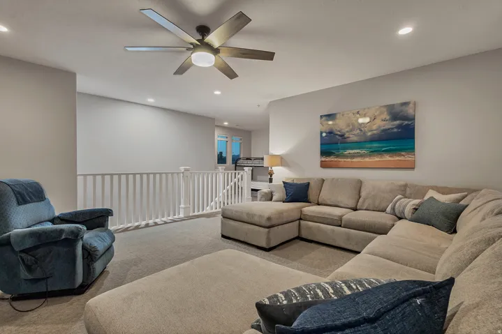 Recessed lighting illuminates the carpeted floor