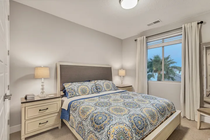 Neutral wall color, window with exterior scenery, carpeted flooring, and a modern flush-mount ceiling light
