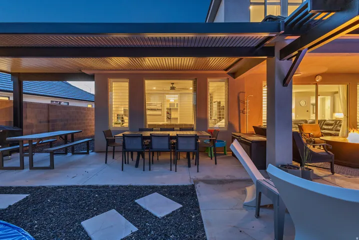 Covered patio featuring an attached pergola, concrete hardscaping, and a gravel ground cover
