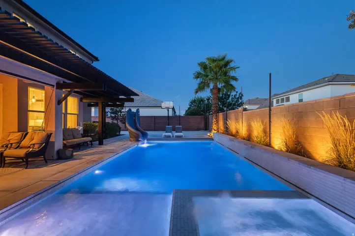 Rectangular swimming pool with integrated spa and water slide