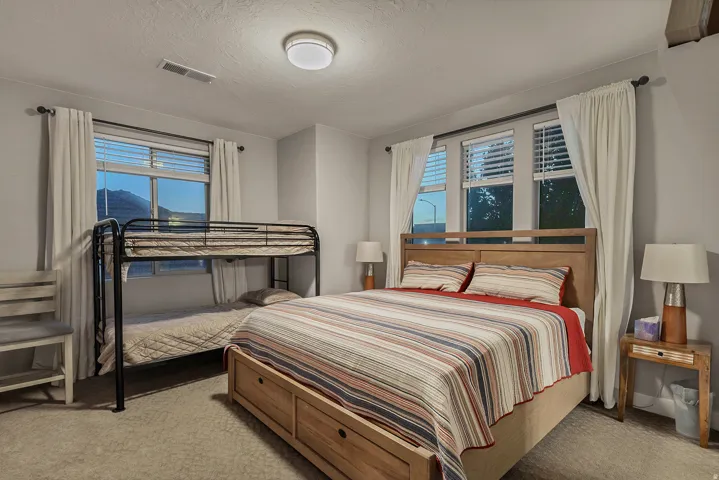 Carpeted room with multiple windows and a flush-mount ceiling light