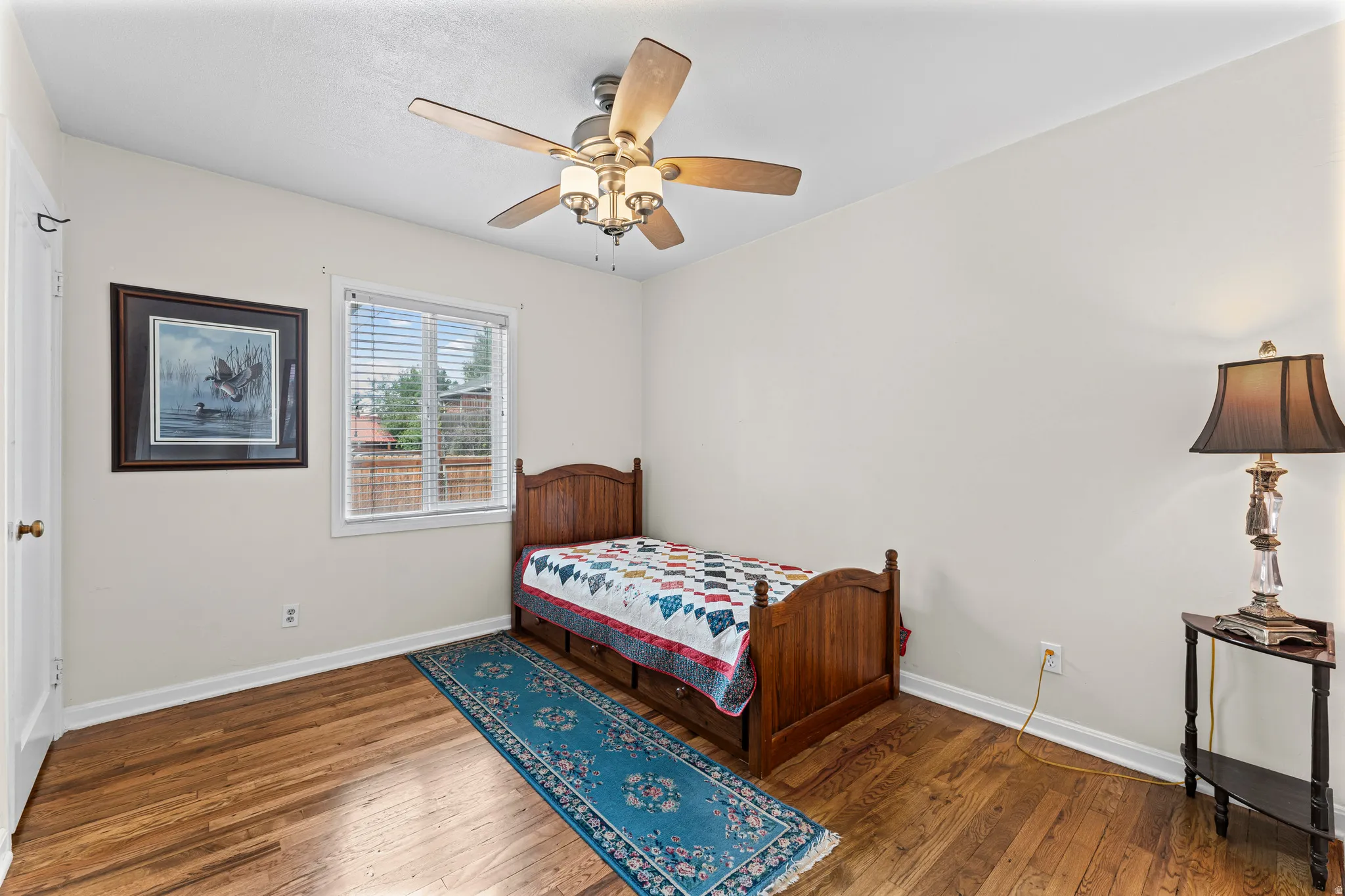 Wood-finish flooring with a ceiling fan light fixture