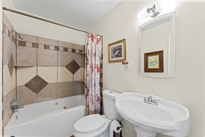 Bathtub with integrated shelving, and tile surround
