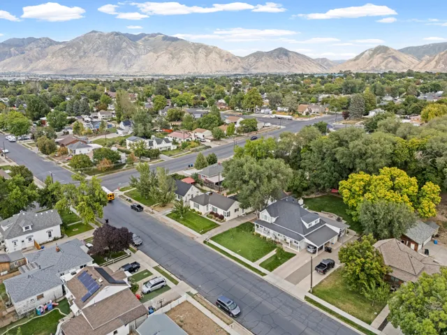 Residential neighborhood with mature trees and mountain scenery