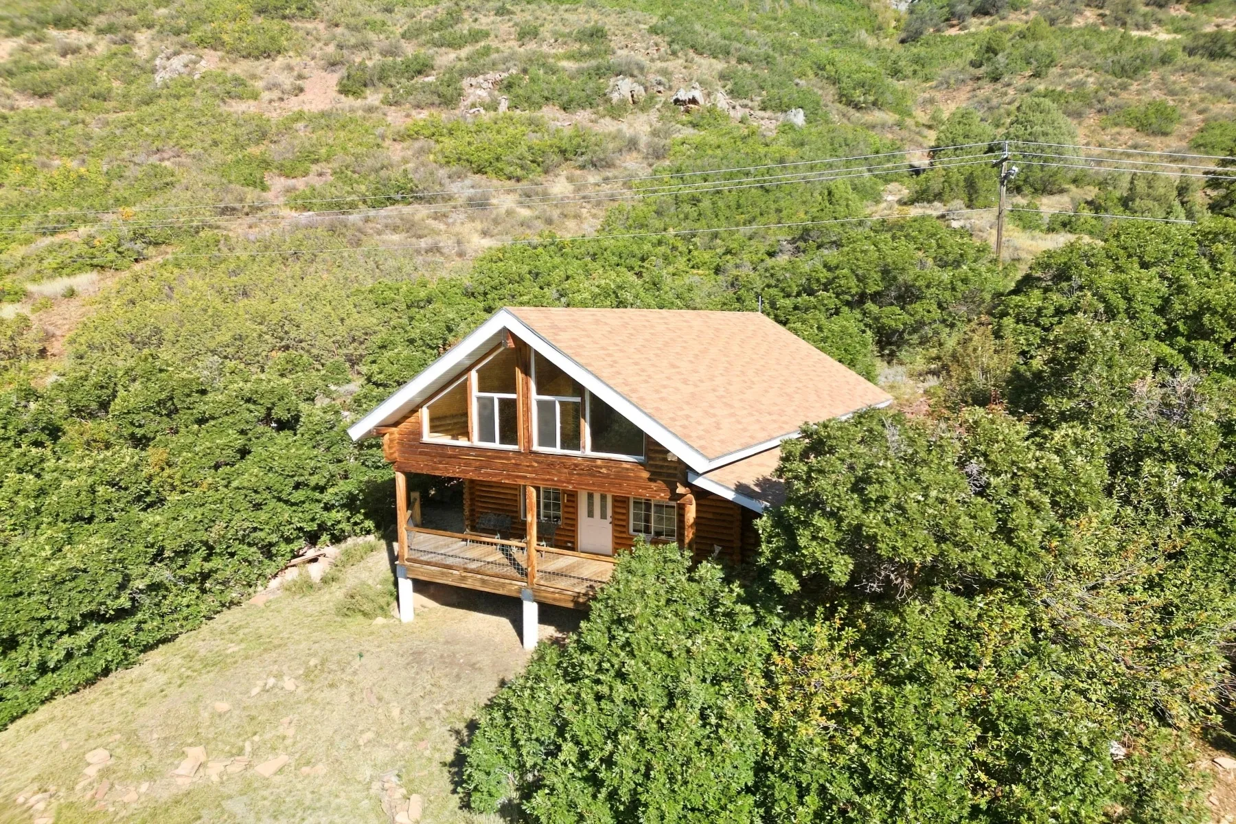 Wood-sided cabin with a gable roof and a full-width covered porch