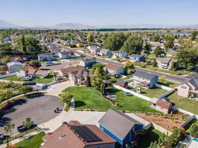 Aerial perspective of a residential neighborhood with distant mountains
