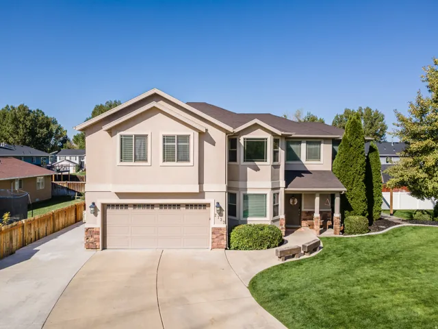 Two-story stucco exterior with stone accents