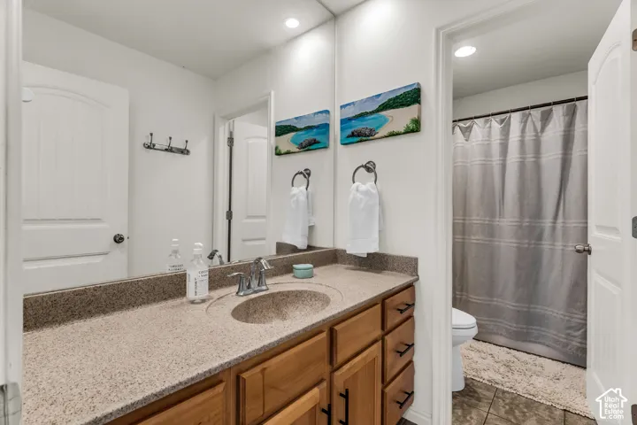 Bathroom vanity with an integrated sink, polished chrome faucet, and wood-finish cabinetry