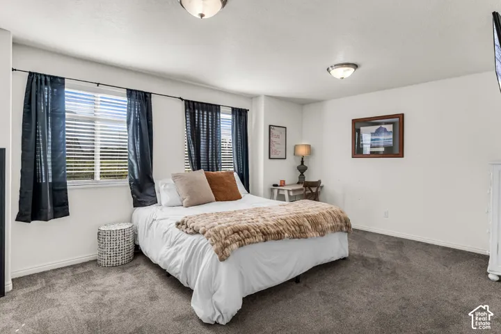 White walls, multiple windows with blinds, and recessed ceiling lights