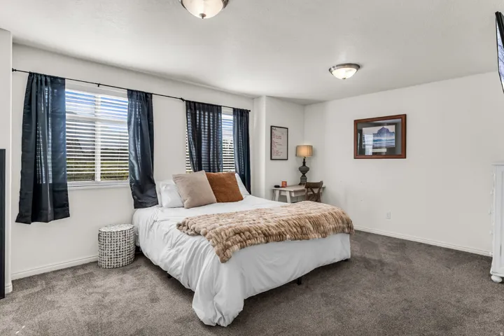 White walls, multiple windows with blinds, and recessed ceiling lights