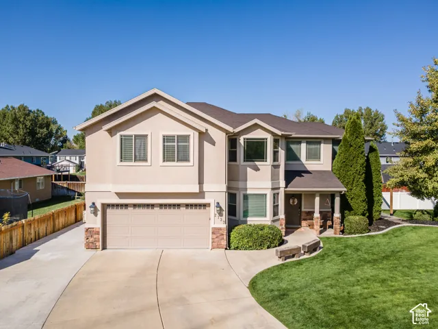 Two-story stucco exterior with stone accents