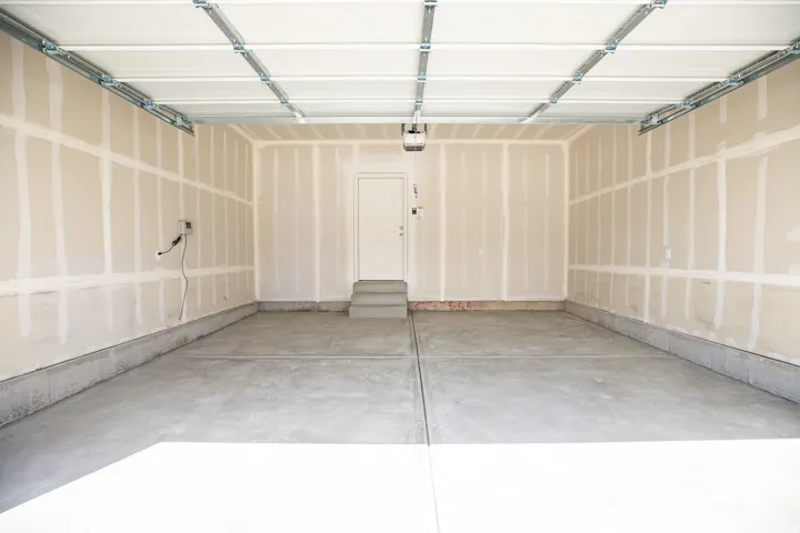 Two-car garage with taped finish.
