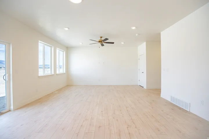 Family room adjacent to open dining area with 9' ceiling and ceiling fan.