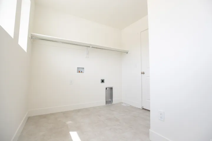 Full-size, dedicated laundry room with natural light and washer/dryer hookups.