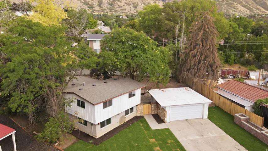 Two-story residence with a pitched roof, attached garage, and concrete driveway