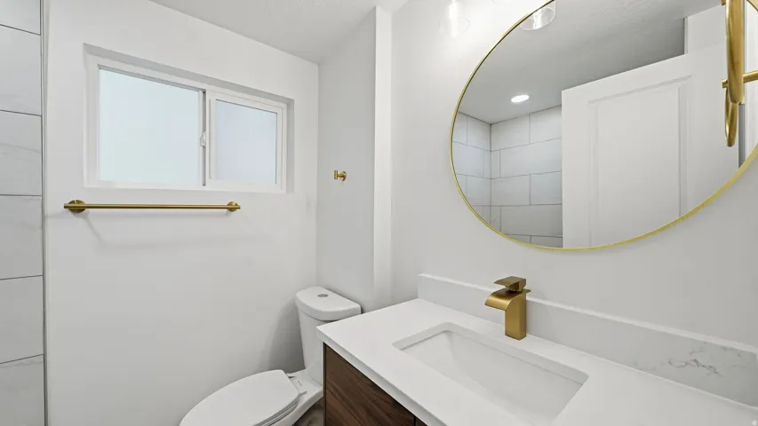 Contemporary bathroom featuring a floating wood-finish vanity with a white countertop and integrated rectangular sink
