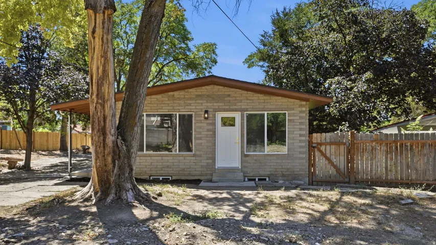 Brick exterior, covered entry, and fenced yard