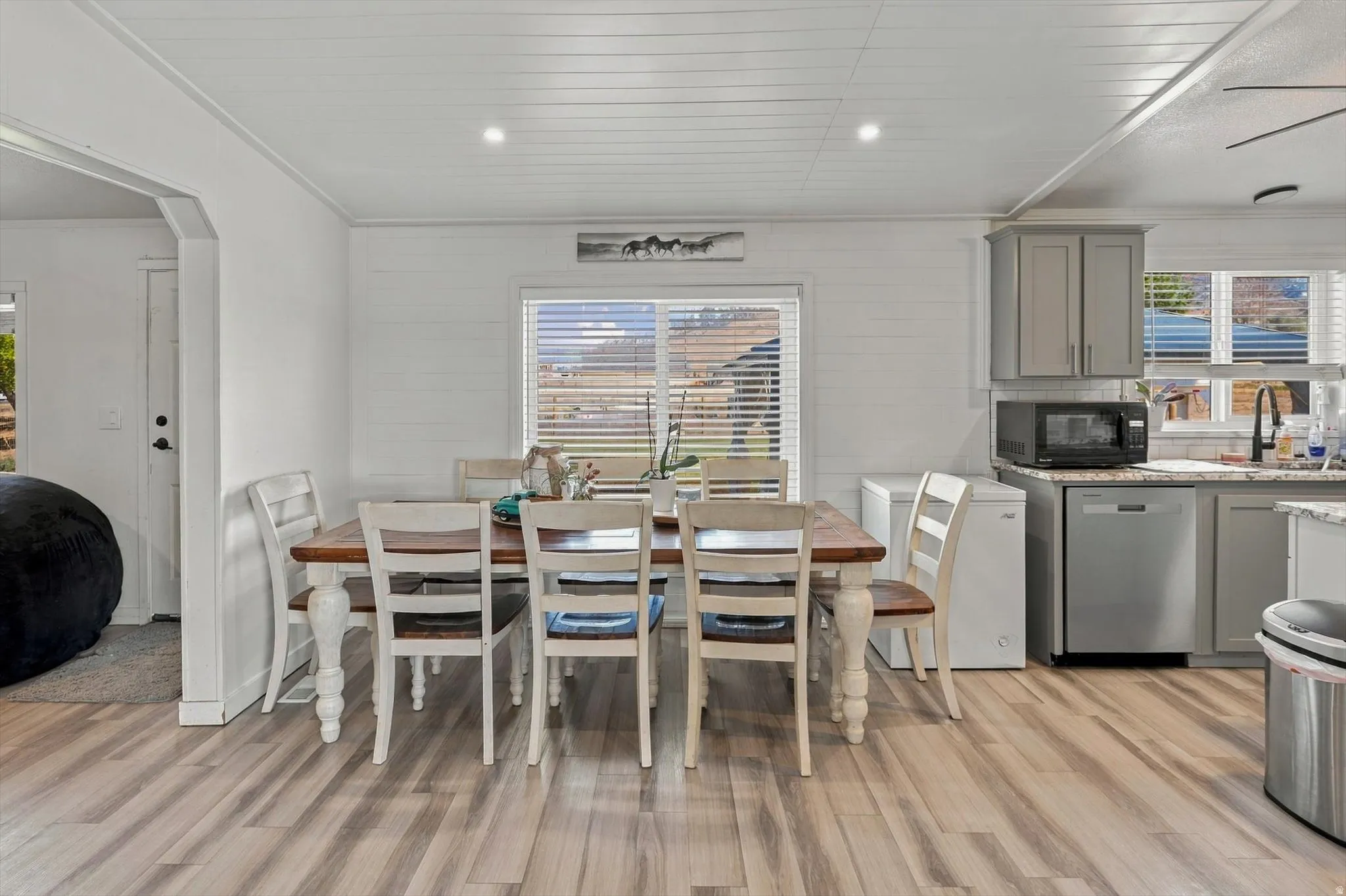 Wood-finish flooring, recessed lighting, and a window with blinds