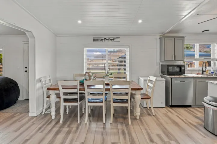 Wood-finish flooring, recessed lighting, and a window with blinds