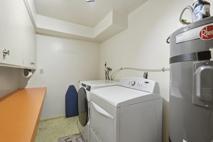 Built-in cabinetry, counter space, and a water heater