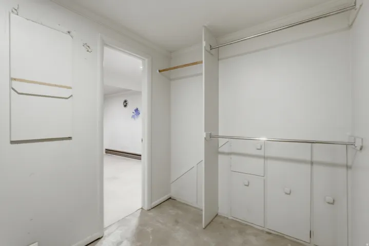Integrated wardrobe system featuring hanging rods and built-in cabinetry